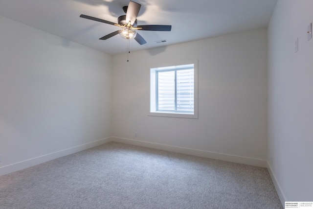 unfurnished room featuring a ceiling fan, carpet, visible vents, and baseboards