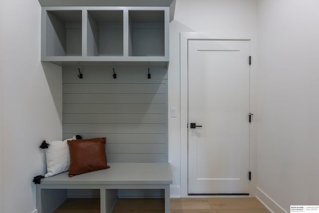 mudroom featuring light wood-style floors and baseboards