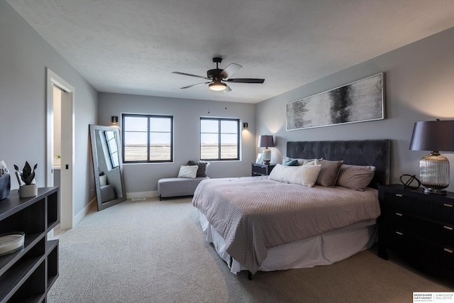 bedroom with a textured ceiling, ceiling fan, baseboards, and light colored carpet