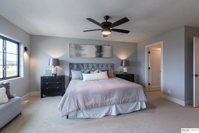 bedroom with light carpet, baseboards, and a ceiling fan