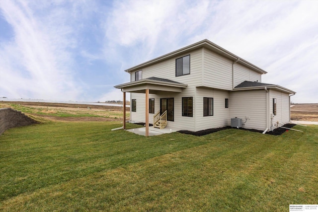 back of house featuring cooling unit, a patio, and a lawn