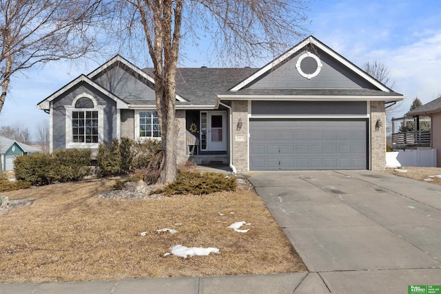 single story home with an attached garage, brick siding, and driveway