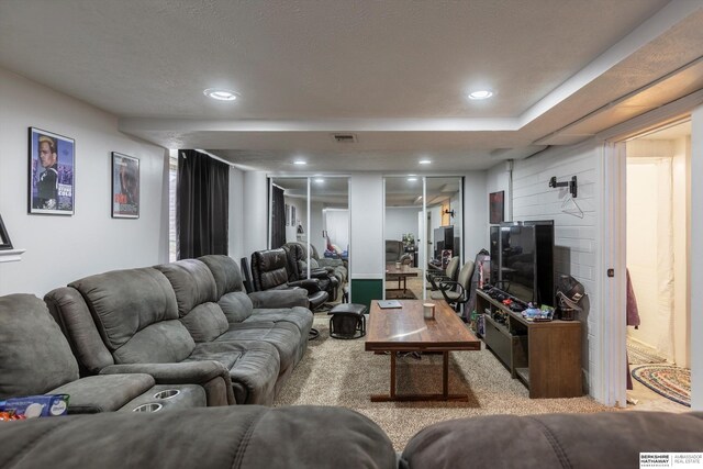 living room featuring recessed lighting, a fireplace, visible vents, and light colored carpet