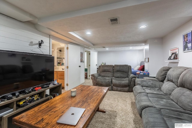 carpeted living area with visible vents and recessed lighting