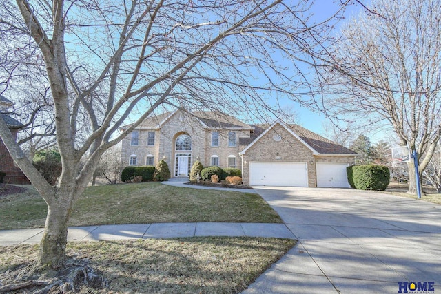 colonial house featuring a front lawn, stone siding, concrete driveway, a garage, and brick siding