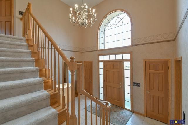 entrance foyer featuring stairway and a towering ceiling