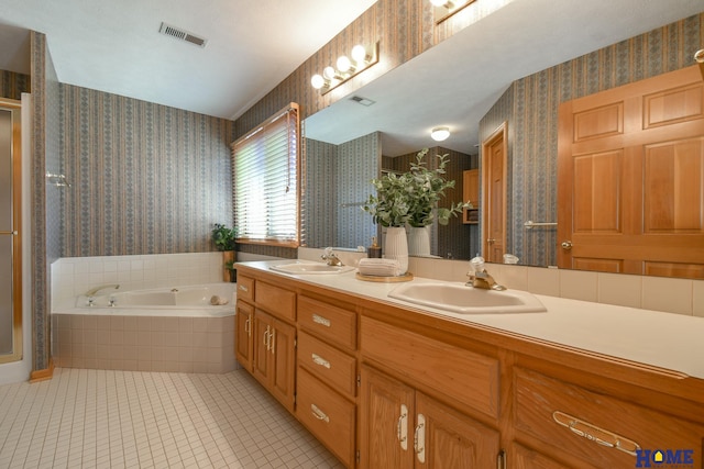 bathroom featuring wallpapered walls, visible vents, and a sink