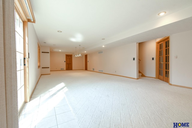 spare room with visible vents, light carpet, recessed lighting, baseboards, and stairs