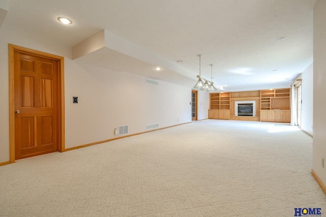 unfurnished living room featuring a tiled fireplace, visible vents, and baseboards