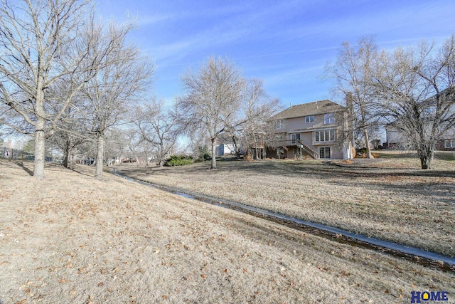 view of yard with stairway and a wooden deck