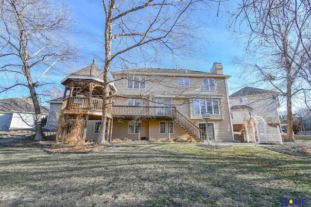 rear view of house featuring stairway, a lawn, a chimney, and a deck