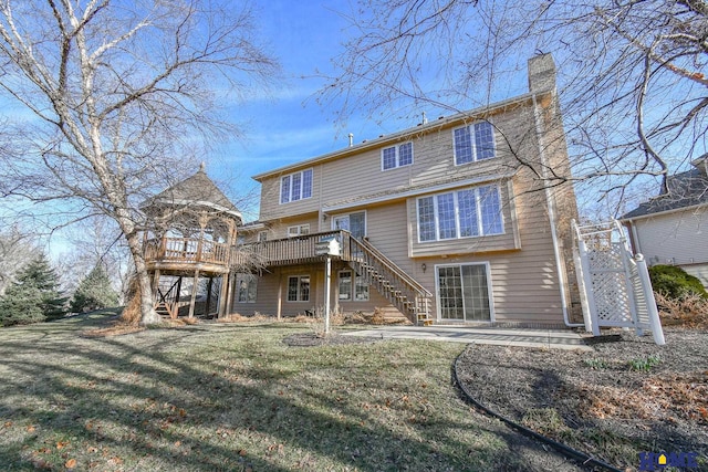 rear view of property with a wooden deck, a yard, a chimney, and stairs