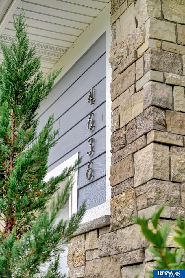 exterior details featuring stone siding