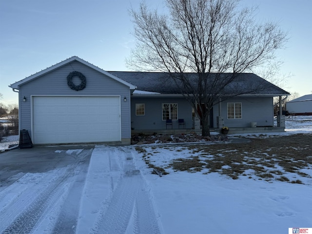 single story home with driveway and a garage