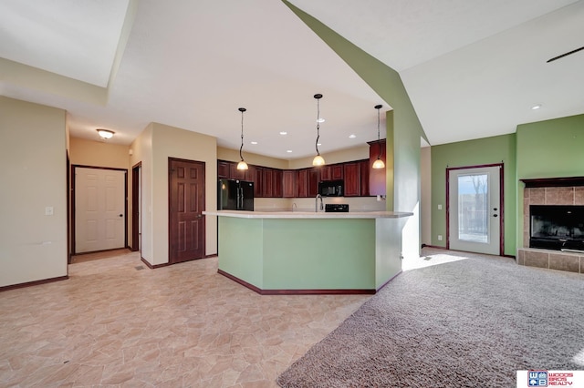 kitchen featuring baseboards, black appliances, light countertops, pendant lighting, and open floor plan