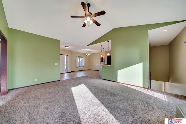 unfurnished living room featuring vaulted ceiling, carpet flooring, baseboards, and ceiling fan