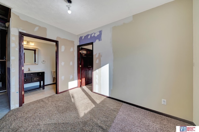 unfurnished bedroom featuring light colored carpet and baseboards