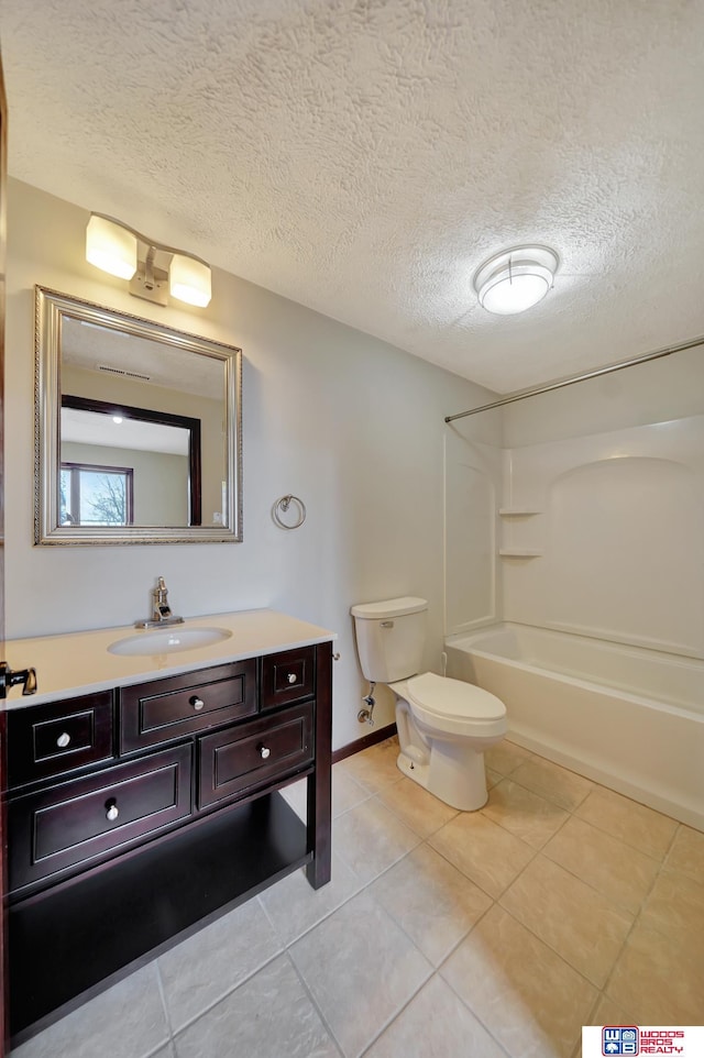 full bath with vanity, tub / shower combination, tile patterned flooring, a textured ceiling, and toilet