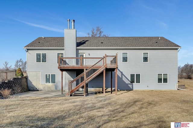 rear view of house featuring a yard, a patio, a chimney, and stairs