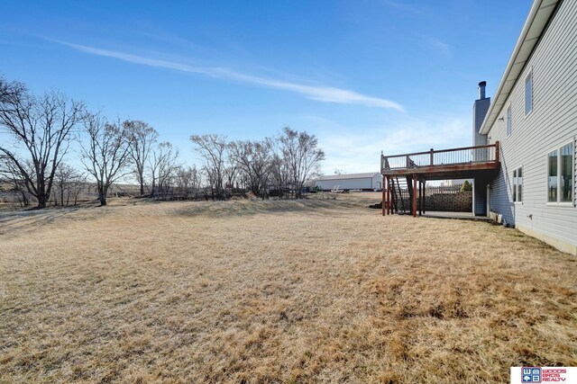 view of yard featuring a wooden deck and stairs