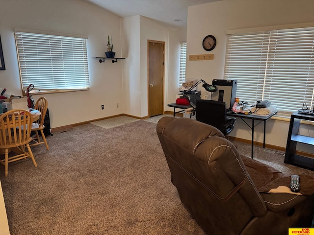 living room featuring lofted ceiling, a healthy amount of sunlight, light colored carpet, and baseboards