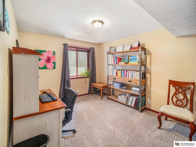 home office with carpet floors, baseboards, and a textured ceiling