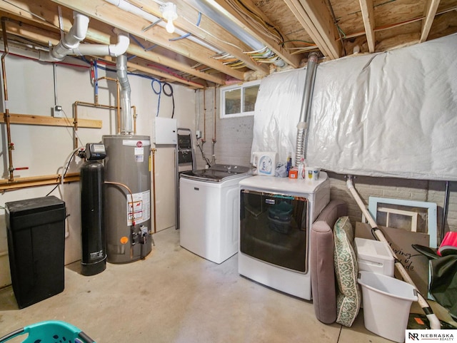 washroom with washer and dryer, laundry area, and gas water heater