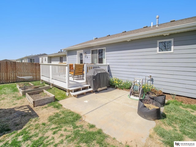 back of house with fence, a garden, a patio area, and a wooden deck