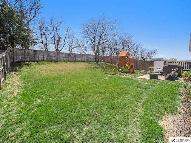 view of yard featuring a fenced backyard and a playground