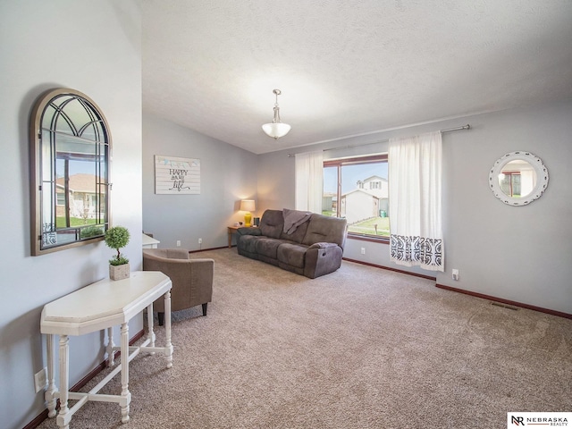 carpeted living room featuring a textured ceiling, baseboards, vaulted ceiling, and visible vents