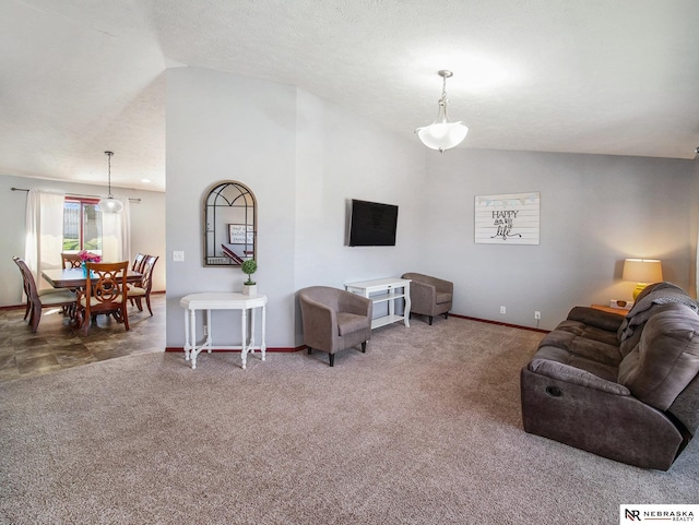 living area featuring baseboards, vaulted ceiling, and carpet