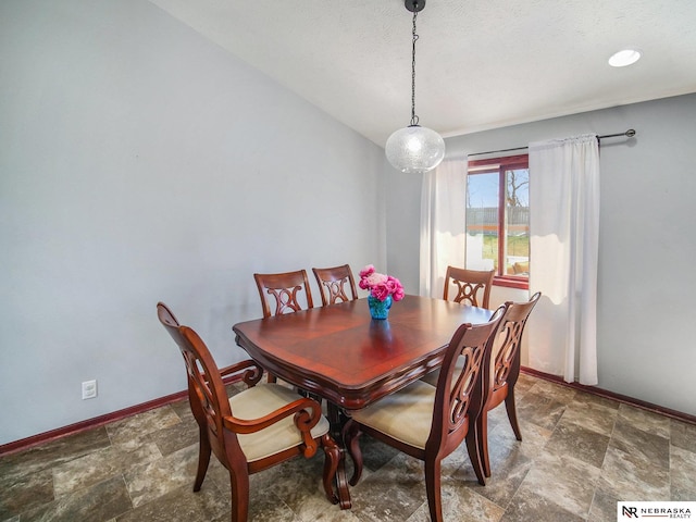 dining area featuring baseboards and stone finish floor