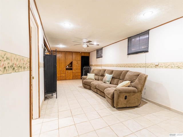 living room featuring light tile patterned floors, recessed lighting, a barn door, a ceiling fan, and wood walls