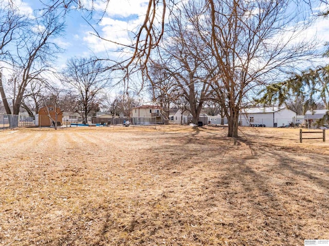 view of yard featuring a residential view and fence