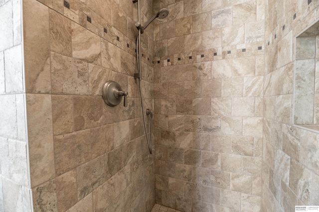 interior details featuring tiled shower