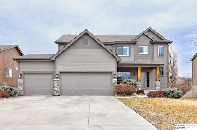 craftsman-style home featuring an attached garage, stone siding, driveway, and roof with shingles