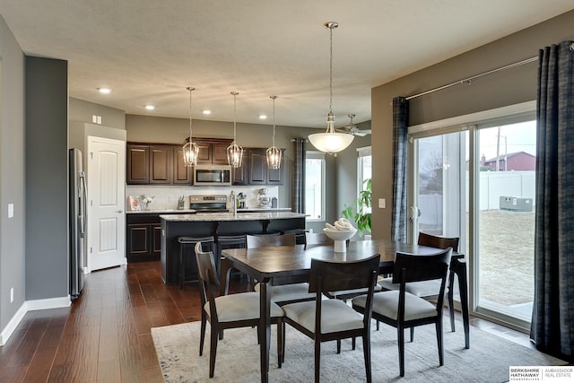 dining room featuring recessed lighting, dark wood-style flooring, and baseboards