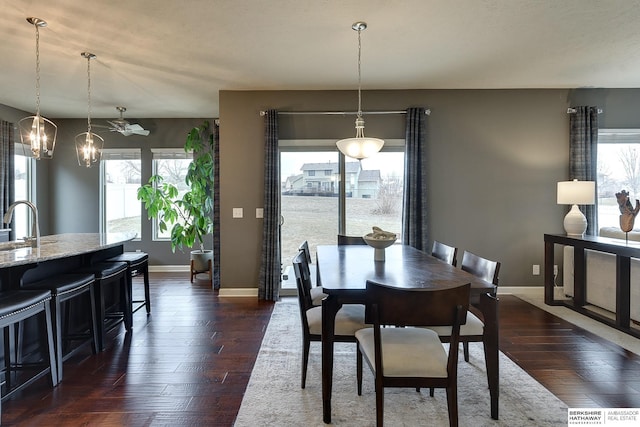 dining room with dark wood-style floors and baseboards