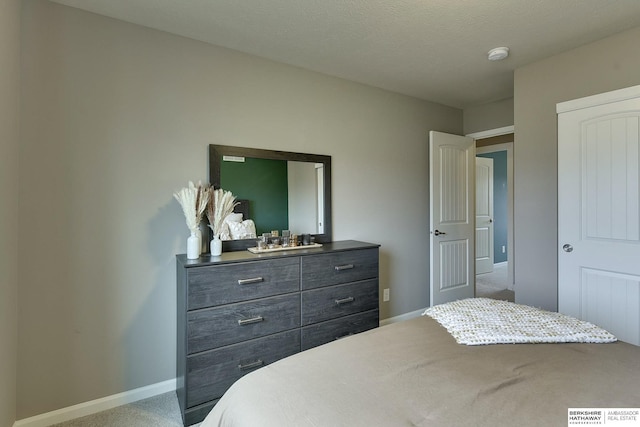 carpeted bedroom featuring baseboards