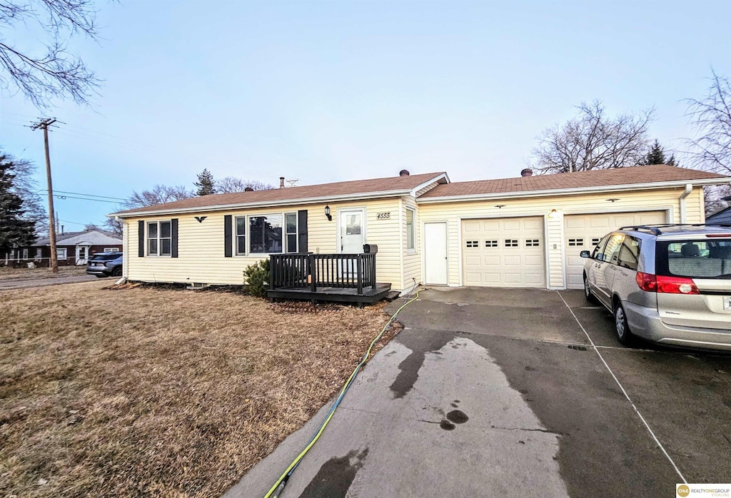 ranch-style house with driveway and an attached garage