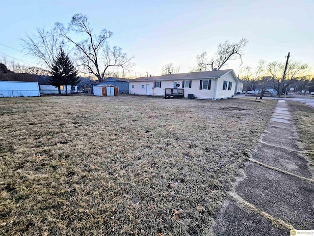 exterior space featuring a shed, an outdoor structure, and fence