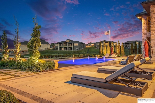 outdoor pool with a patio and a residential view