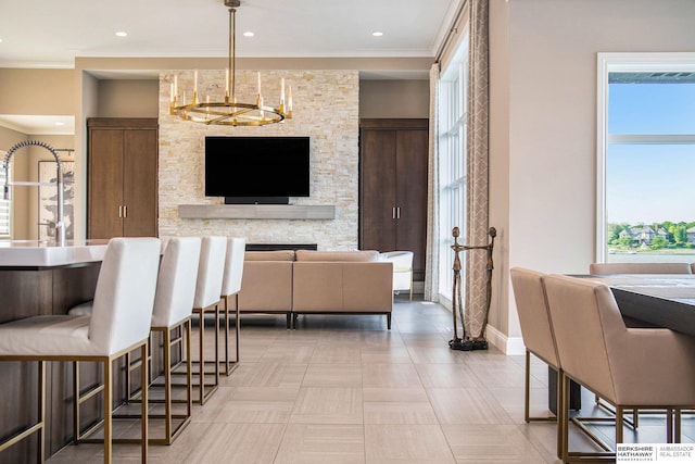 interior space featuring baseboards, ornamental molding, recessed lighting, and a notable chandelier