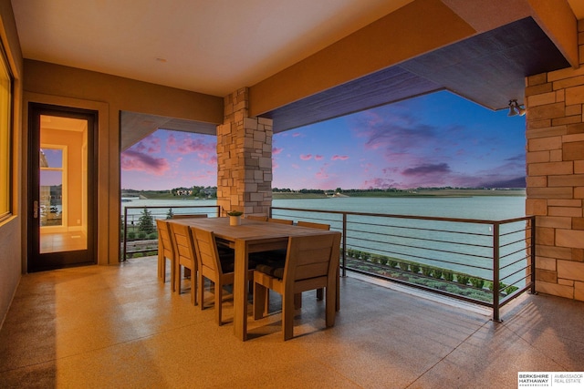 view of patio / terrace with visible vents, outdoor dining space, a water view, and a balcony