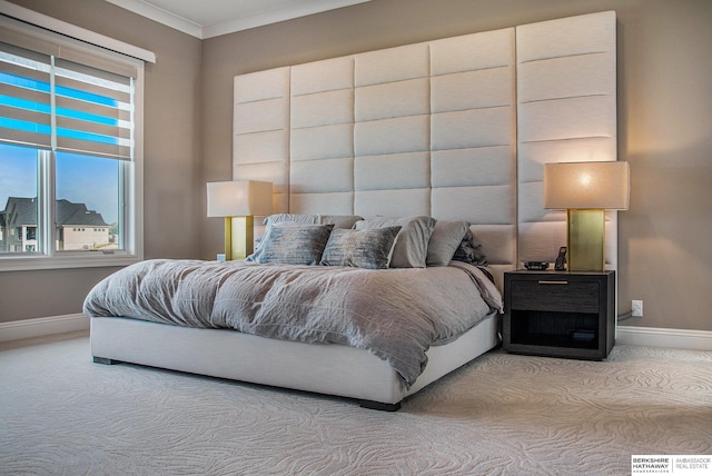 bedroom with ornamental molding, light colored carpet, and baseboards