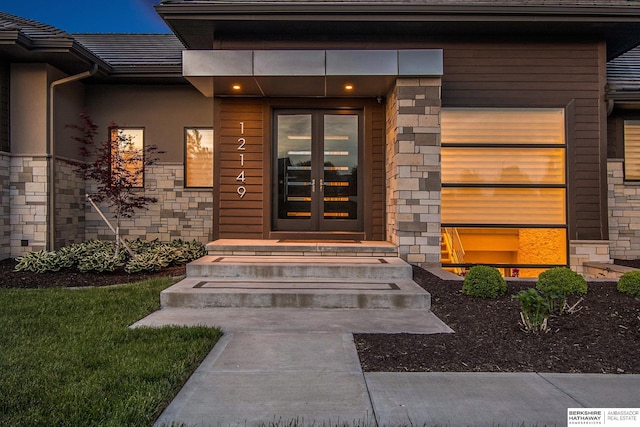 entrance to property featuring stone siding