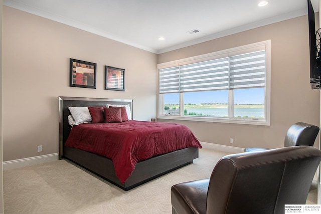 carpeted bedroom with crown molding, a water view, visible vents, and baseboards