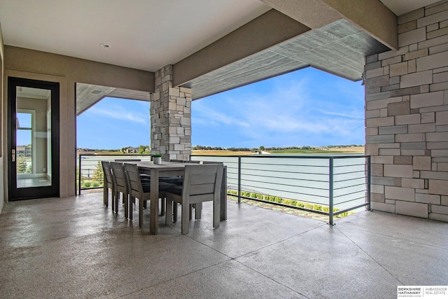 view of patio with outdoor dining area and a balcony