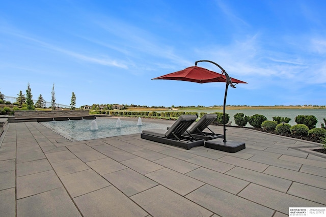 view of patio / terrace with a water view and an outdoor pool