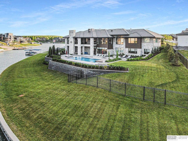 exterior space featuring a yard, a water view, a fenced backyard, and a community pool